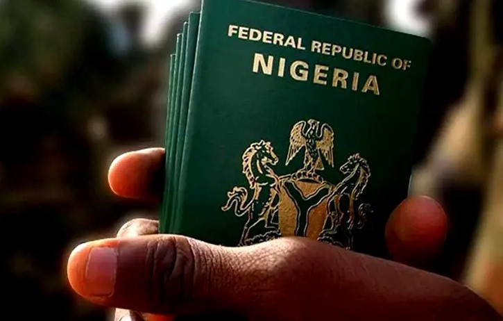 Nigerian passport held by black hands