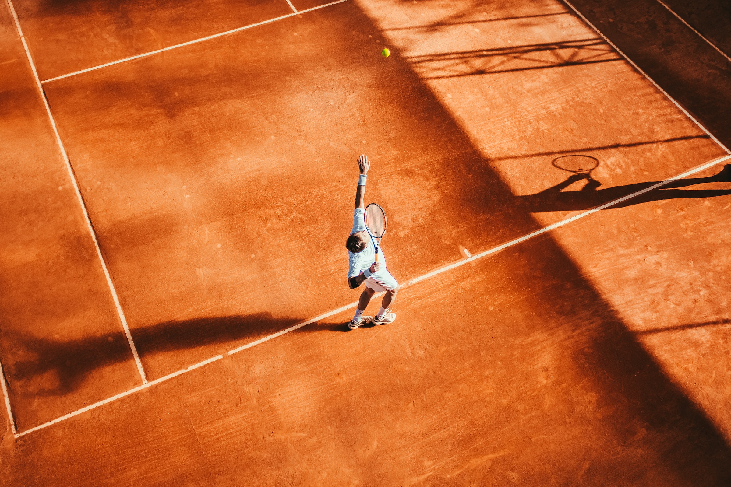 Man serving in a tennis match