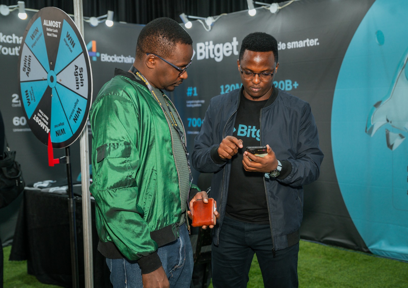 Two men standing side by side in a Bitget event